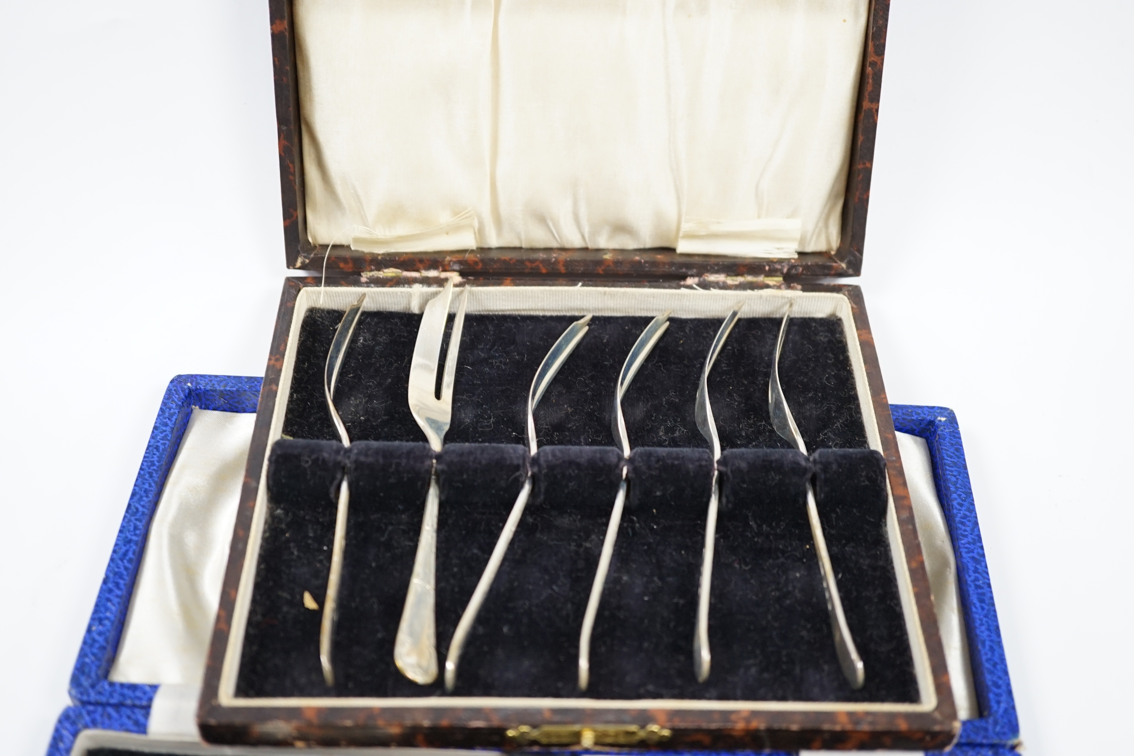 A George VI cased silver christening trio, Sheffield, 1946/7, a matched silver christening pair and a cased set of six silver pastry forks. Condition - fair to good